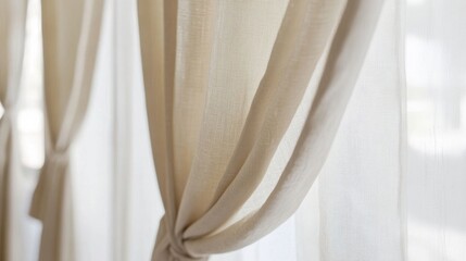 Soft beige curtains tied elegantly.