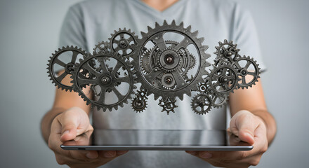 Man Holding Tablet with Gears Forming Cloud in Digital Technology Concept Presentation with Gray Background