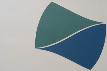 two similar cut paper shapes with triangle element and pointy edge on beige