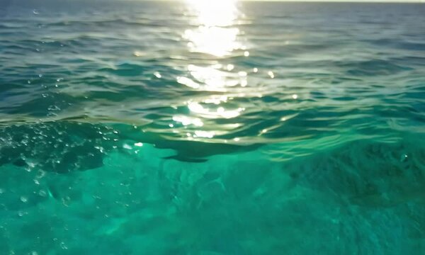 Sea water surface. Low angle view over clear azure sea water. Sun glare. Abstract nautical summer ocean nature. Holiday, vacation and travel concept. Nobody. Slow motion. Weather and climate change
