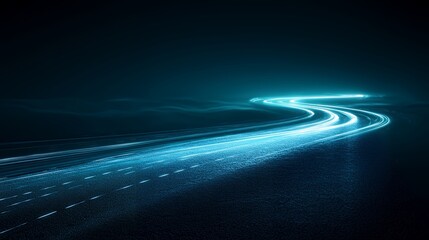 A winding road at night, illuminated by the bright streaks of headlights.  The dark landscape creates a sense of mystery and movement