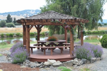 A charming wooden gazebo surrounded by lavender and greenery, overlooking a serene pond and distant hills.
