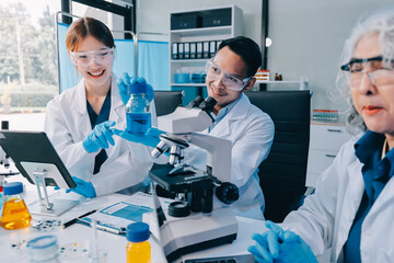 Asian people scientist in lab coat and protective gloves working with test tubes with green and red...