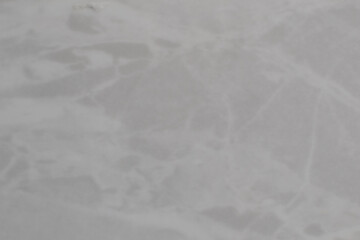 White crumpled plastic texture creating abstract shapes and shadows