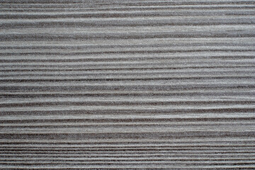 Dark gray wood texture with thin horizontal lines creating a striped pattern