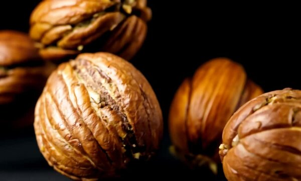 Walnuts gyrating on black background