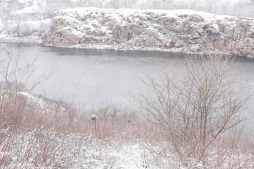 Zaporizhzhia, Ukraine. Beautiful winter on Khortytsia island. Dnipro river, cliffs, snow-covered river bank, scenic view.