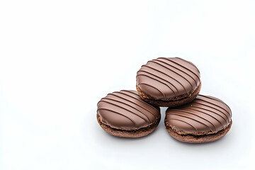 Three chocolate cookies with striped icing, stacked on white background