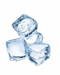 Three glistening ice cubes, wet and translucent, isolated on white