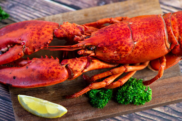 Red lobster on wooden cutting board 