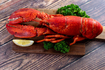 Red lobster on wooden cutting board 