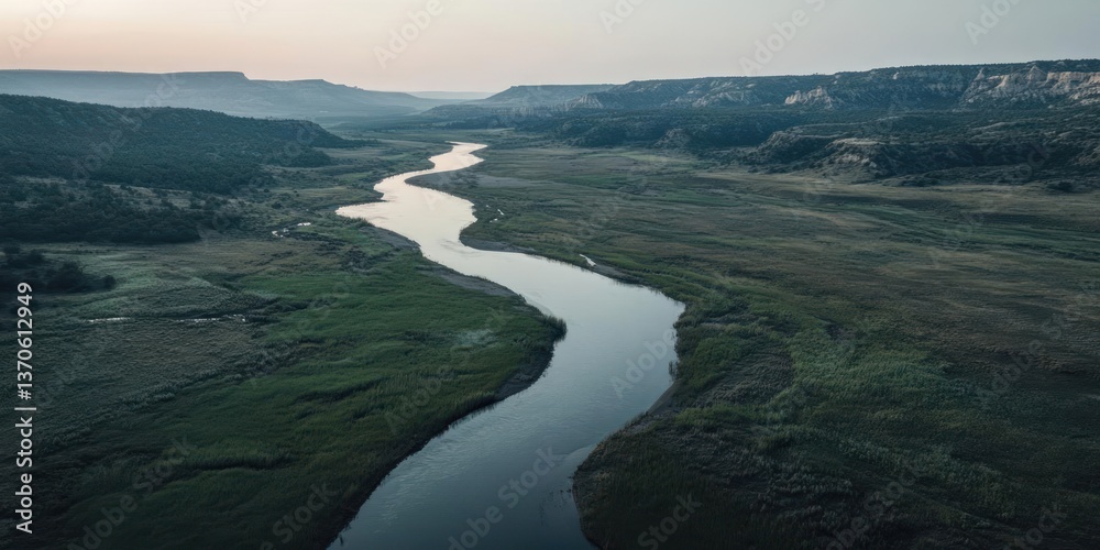 Poster aerial view of a winding river flowing through a canyon landscape with lush greenery and distant lan