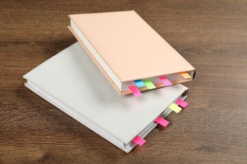Books with colorful tabs on wooden table