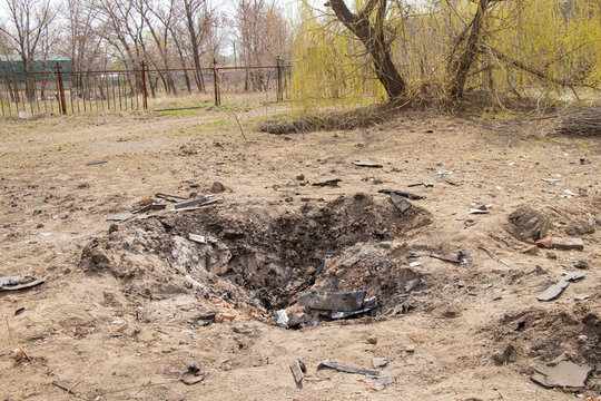 A crater from a drone strike on the embankment on Pobedy in Ukraine in Dnepr