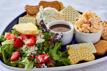 chicken salad and pimento cheese dip served with assorted crackers and a side salad