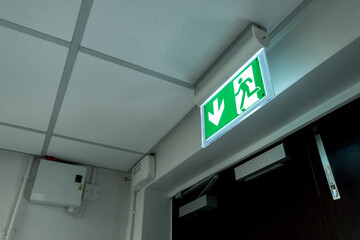 Industry-standard illuminated Fire Exit sign seen at the fire escape and emergency exit doors...