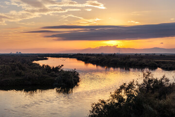 Fototapeta premium Beautiful sunset or sunrise on the wetland National Park Delta Evros in Thrace Greece near to Feres and Alexandroupolis, near Greek Turkish borders, panoramic view