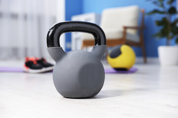 One kettlebell on floor at home. Sports equipment