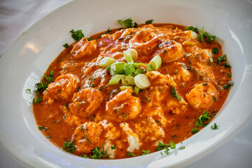 shrimp and grits with andouille sausage topped with a tomato gravy