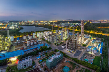 Fototapeta premium Aerial view of large oil refinery factory complex at dusk