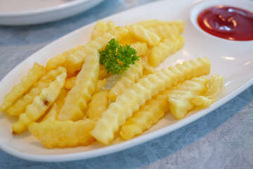 Delicious crinkle-cut fries with ketchup restaurant food bright environment close-up tasty snack