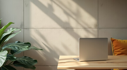laptop on wooden desk in sunlit workspace with plant and yellow pillow