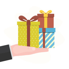 Human hand holding colorful gift boxes. Businessman hand hold present box gift, christmas or birthday presents, bonus for employees. Celebration, boxing day, congratulation.