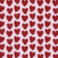 Hand drawn doodle heart seamless pattern on pink background.