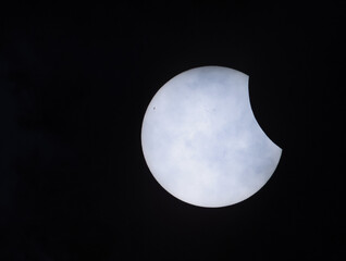 Partial solar eclipse on 29.03.2025 in Germany, northern Germany, near Bremen, veil clouds can be seen in the foreground.