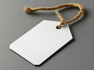 White Textured Tag with Jute Rope on Gray Surface, Blank Paper Label, View