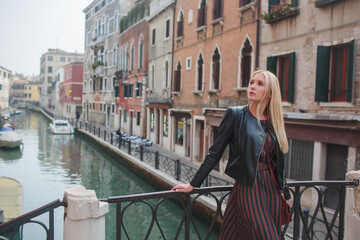 A Young Woman Dressed in a stylish Leather Jacket in a Vibrant Urban Setting