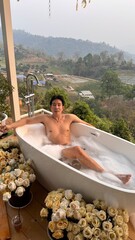 Handsome Man Relaxing in a Bubble Bath at a Chiang Mai Resort in his Honeymoon trip