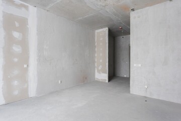interior of the apartment without decoration in gray colors. rough finish