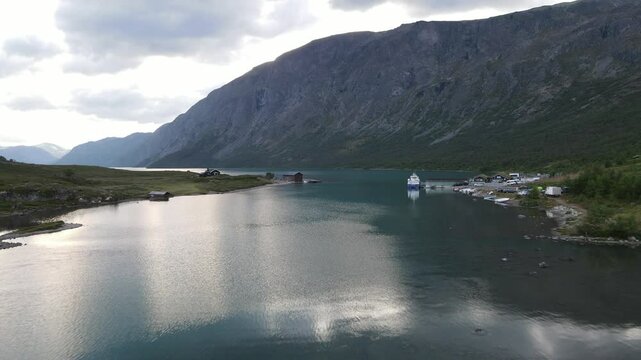 Stunning view from Besseggen Ridge in Jotunheimen National Park, Norway, with a dramatic contrast between the turquoise Lake Gjende and the deep blue Lake Bessvatnet.