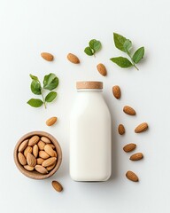 almond milk bottle Fresh almond milk surrounded by almonds and green leaves.