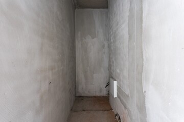 interior of the apartment without decoration in gray colors. rough finish