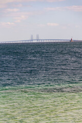 Obraz premium Oresund bridge seen from Amager beach park, Copenhagen, Denmark, sunny day