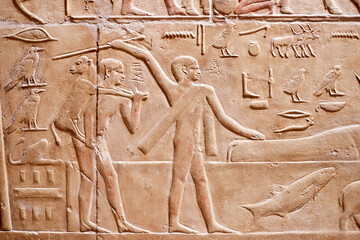 A mural from the tomb of the vizier Kagemni showing men crossing the river together with a herd of cows, one carrying a calf on his shoulders