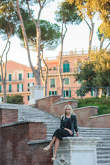 Fototapeta premium A Stylish Woman Taking Time to Relax in a Beautiful Historic Roman Landscape Setting