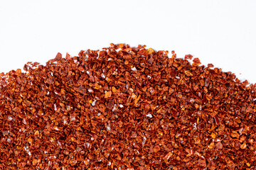 Crushed red hot chili pepper natural seasoning, white background, copy place for text, top view