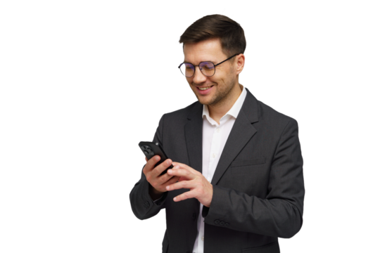 Professional man in a suit smiles while using a smartphone in a bright, minimal setting