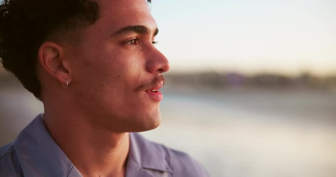 Man, smile and sunset at ocean with thinking, relax and fresh air with travel. Person, happy and face at beach with peace, vacation break and deep breath for mindfulness with space at seaside