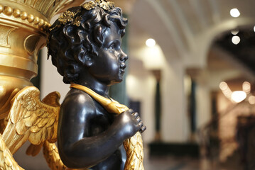 Fototapeta premium Gold-trimmed small angel figurine