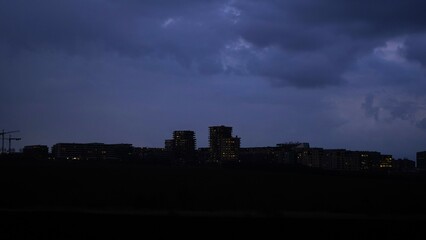 City sleeps. Lights flicker. Clouds gather. Silence spreads.