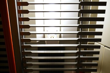 Window blinds. Horizontal slats. Indoor lighting. Modern design.

