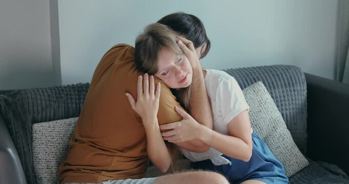 Couple embracing on couch, emotional support, cozy home atmosphere. Great for love, relationships, comfort, warmth, intimate bonding.