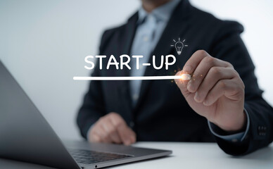 Businessman drawing a startup concept with glowing digital effects, representing entrepreneurship, innovation, and business growth strategy
