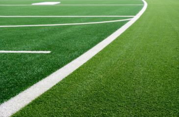 close-up view the green grass of a sports field, associated with athletic activities and outdoor recreation.
