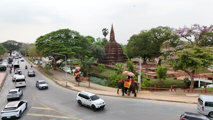 Tourists ride an elephant through the streets of Ayutthaya cultural. © Y U K C U T E