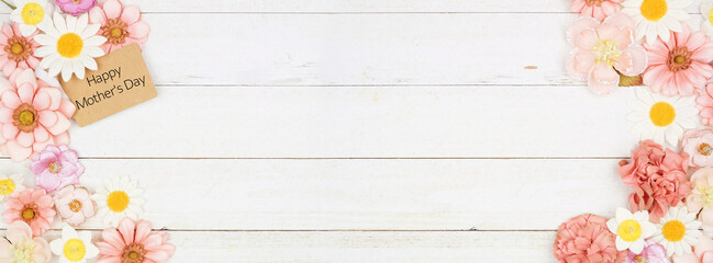 Happy Mothers Day gift tag with paper flower double border. Top down view on a white wood banner background. Copy space.
